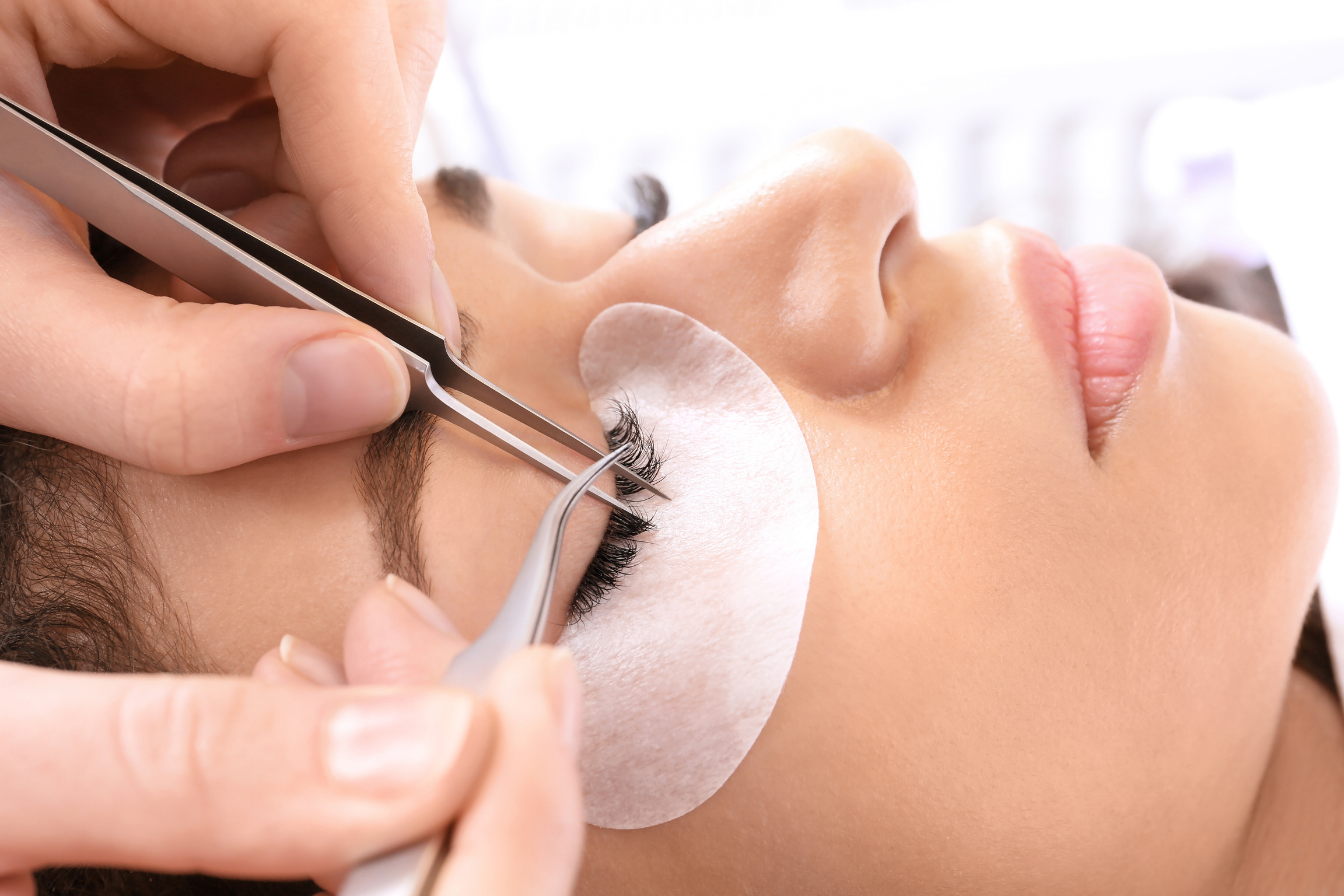 Young Woman Undergoing Eyelash Extensions Procedure